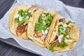 3 Carne Asada street tacos Mexican white onion cilantro corn tortillas white paper black tray Royalty Free Stock Photo