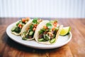 carne asada tacos with fresh salsa verde and limes