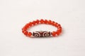 Carnelian stone Dzi bead 3 eyes bracelet. Bracelet made of stones on hand from natural Carnelian. Handmade jewelry bracelets on Royalty Free Stock Photo