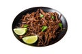 Carnitas in a plate with celery and lime wedges. Isolated on white background. Top view.