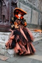 Carnival black-orange mask and costume at the traditional festival in Venice, Italy