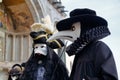 Carnival black-white mask and costume at the traditional festival in Venice, Italy