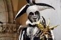 Carnival black-white mask and costume at the traditional festival in Venice, Italy