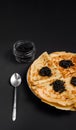 carnival celebration dish: pancakes with black sturgeon caviar on a plate