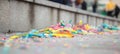 Carnival colorful serpentines on blurred pavement background. Close up view, banner, space for text.