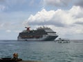 Carnival cruise ship and transfer tour boat image near the harbour pier of Georgetown, Grand Cayman, Cayman Islands