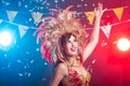 Carnival, dancer and holiday concept - Beauty brunette woman in cabaret suit and headdress with natural feathers and