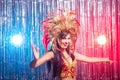 Carnival, dancer and holiday concept - Beauty brunette woman in cabaret suit and headdress with natural feathers and