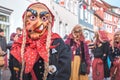 Carnival figure with a crooked nose and pigtails.