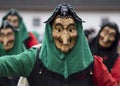 Carnival goer in a carved wooden mask