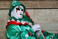 Carnival green-white-red mask and costume at the traditional festival in Venice, Italy