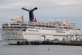 The Carnival Inspiration Cruise Ship docked at the Long Beach Harbor on a cloudy afternoon.