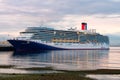 Carnival Luminosa docked at Pier 91 Seattle in dawn light with water reflection