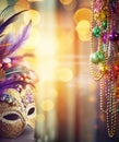 Carnival mask, colorful Mardi Gras beads and bokeh lights festive background Royalty Free Stock Photo