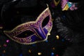 Carnival mask with confetties on black background