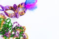 Carnival mask with feathers and colorful beads on white background. Mardi Gras or Fat Tuesday symbol.