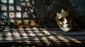 A carnival mask lies on a old wooden table, against the background of a brick wall. Banner Royalty Free Stock Photo