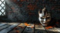 A carnival mask lies on a old wooden table, against the background of a brick wall. Banner Royalty Free Stock Photo