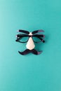 Carnival mask with moustache, nose and glasses on blue background, copy space. Concept Movember, men`s health, prostate cancer