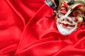 Carnival mask on red satin background Royalty Free Stock Photo