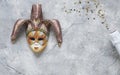 Carnival mask, white champagne bottle and gold glitter confetti. Top view, Close up on marble background Royalty Free Stock Photo