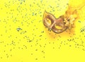 Carnival mask on yellow background with sparkles. Festive backdrop for projects. Royalty Free Stock Photo