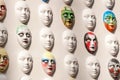 Carnival masks hanging on wall boards lie Royalty Free Stock Photo