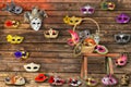 Carnival masks hanging on wall boards lie on floor and bench i