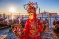 Carnival masks with mirror against gondolas in Venice, Italy Royalty Free Stock Photo