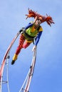 Carnival of Nice, Flowers` battle. An acrobat woman with clown costume on sky background