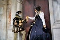 Carnival pair black-white-gold mask and costume at the traditional festival in Venice, Italy