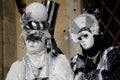 Carnival pair black-white-silver mask and costume at the traditional festival in Venice, Italy