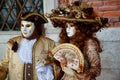 Carnival pair brown-gold mask and costume at the traditional festival in Venice, Italy