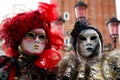 Carnival pair red-black-gold mask and costume at the traditional festival in Venice, Italy