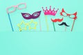 carnival party celebration concept with paper photo booth props over yellow background. Top view. Flat lay.