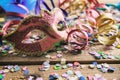 Carnival party. Mask, confetti and serpentines on wooden background Royalty Free Stock Photo