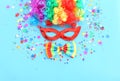 Carnival, party and Purim celebration concept jewish carnival holiday over blue background