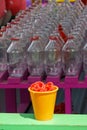 Carnival ring toss game with a yellow cup full of red rings in the foreground Royalty Free Stock Photo