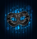 Carnival or theater mask on blue shimmering background