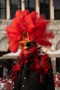 Carnival of Venice 2024 edition - Aristocrat with gigantic red feathery mask Royalty Free Stock Photo