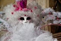 Carnival white-pink mask and costume at the traditional festival in Venice, Italy