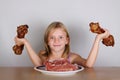 Carnivore keto diet concept - little blond girl eating raw meat Royalty Free Stock Photo