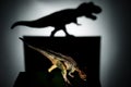 Carnotaurus casting a tyrannosaurus shadow in dark
