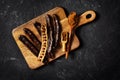 Carob bean and powder on board flat lay on black background