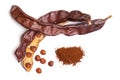 Carob beans with powder. Healthy organic sweet carob pods with seeds on white background. Top view