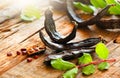 Carob. Healthy organic sweet carob pods with seeds and leaves on a wooden table. Healthy eating, food background Royalty Free Stock Photo