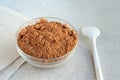 Carob powder in small saucer on the table