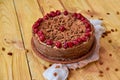 Carob tart with cherries ans raisins on the wooden background. Powdered carob pie with cherries Royalty Free Stock Photo