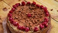 Carob tart with cherries ans raisins on the wooden background. Powdered carob pie with cherries Royalty Free Stock Photo