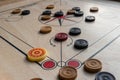 Carom board with striker, carom men, and queen.